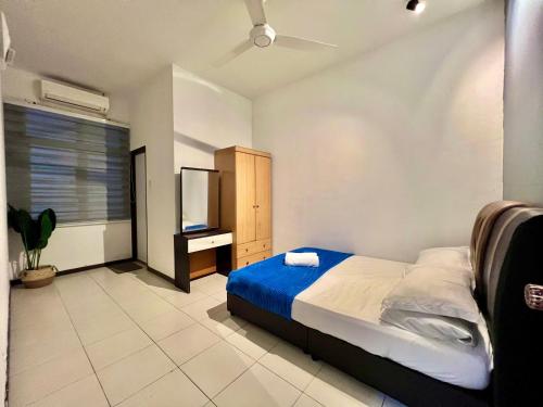 a bedroom with a bed and a flat screen tv at Medina Homestay Chukai Kemaman in Cukai