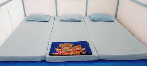 a twin bed in a small room with a toy at Curug Ciherang Villa & Glamping in Nangeleng