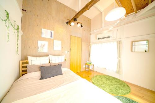 a bedroom with a large bed and a green rug at Smile STAY Shin Nakano/ Vacation STAY 8453 in Tokyo