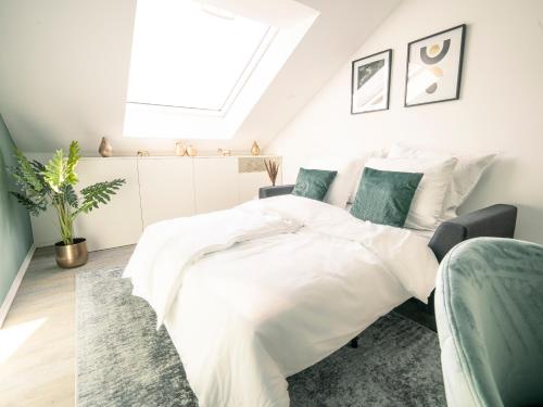 a bedroom with a white bed and a skylight at Deluxe Suite - Living & Work Place in Gießen
