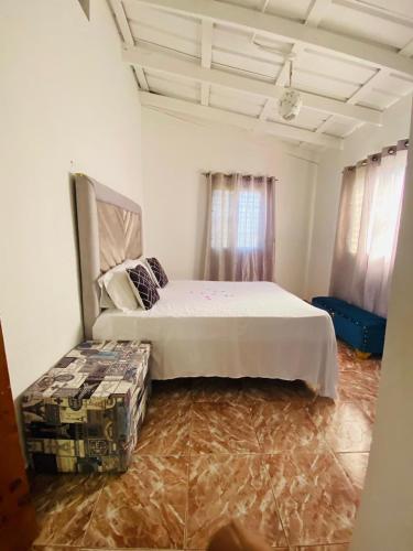 a bedroom with a bed and a couch in it at Villa Marcia in Boca Chica