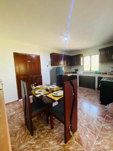 a kitchen with a table and chairs in a kitchen at Villa Marcia in Boca Chica