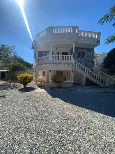 a large house with a balcony on top of it at Villa Marcia in Boca Chica