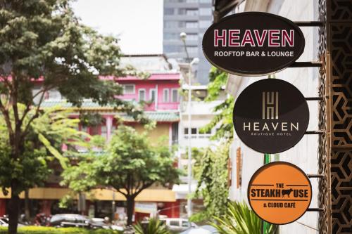 a sign for a bar in a city with buildings at Heaven Boutique Hotel in Bangkok