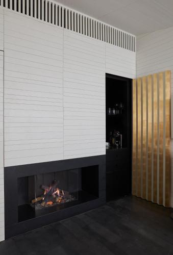 a fireplace in a living room with a fire place at Casa Palacio PAREDES SAAVEDRA by ATRIO in Cáceres
