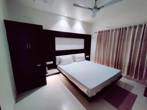 a bedroom with a bed with a black headboard at Abu Inn, Mount Abu - The Luxury Boutique Stay in Mount Ābu