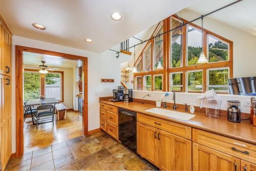 a kitchen with wooden cabinets and a large counter top at Walk-In Skiing/Tubing Across at Summit East in Snoqualmie Pass