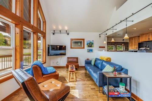 a living room with a blue couch and chairs at Walk-In Skiing/Tubing Across at Summit East in Snoqualmie Pass