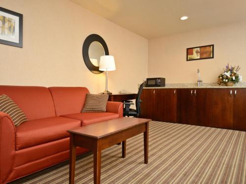 a living room with a couch and a table at Yellowstone West Gate Hotel in West Yellowstone