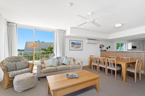 a living room with a couch and a table at Las Rias Holiday Apartments in Noosa Heads