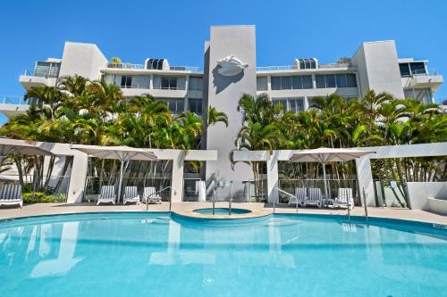 a large swimming pool in front of a building at Las Rias Holiday Apartments in Noosa Heads
