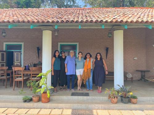 a group of women standing in front of a house at Ella Nine Peaks in Ella