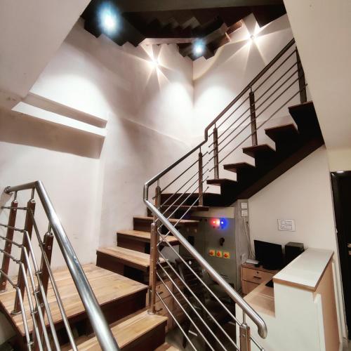 a spiral staircase in a building with lights on it at Abu Inn, Mount Abu - The Luxury Boutique Stay in Mount Ābu