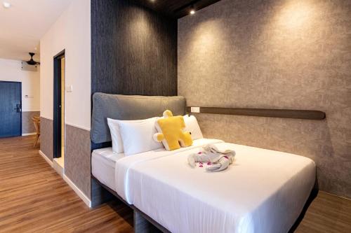 a bedroom with a bed with a teddy bear on it at Bagan Suite in Butterworth