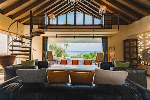 a living room with a couch and a table at GLAMDAY VILLA OKINAWA NAKAMURATEI in Meta