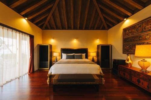a bedroom with a large bed and a large window at GLAMDAY VILLA OKINAWA NAKAMURATEI in Meta