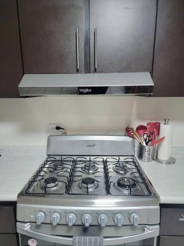 a stove top oven sitting in a kitchen at Tu Casa de Familia in Tijuana