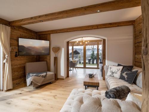 a living room with a couch and a table at Alpine Lodge Brixen in Brixen im Thale