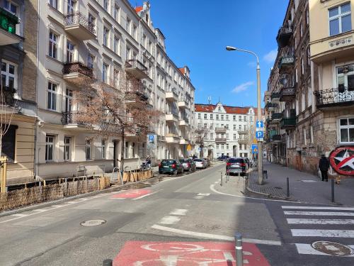 an empty street in a city with buildings at Prad 543 in Poznań
