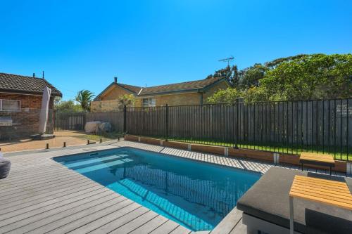 a swimming pool in a backyard with a fence at Serene Pet Friendly with Swimming Pool in Culburra Beach