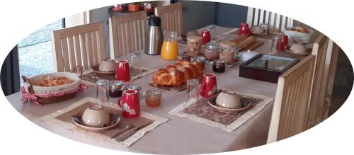 a table with bread and other food on it at Au P'tit Versailles in Châtillon-sur-Seine