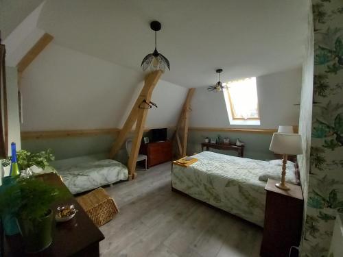 a bedroom with two beds and a window at Au P'tit Versailles in Châtillon-sur-Seine