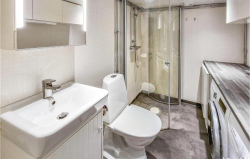 a bathroom with a toilet and a sink and a shower at Nice Home In Skvde With Kitchen in Skövde