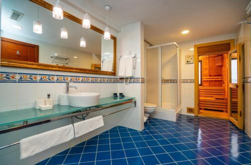 a bathroom with a sink and a toilet and a mirror at Anemon Eskisehir Hotel in Eskisehir