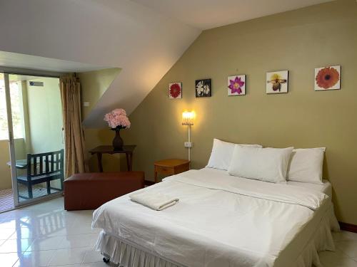 a bedroom with a large white bed in a room at Nawaporn Place in Phuket Town