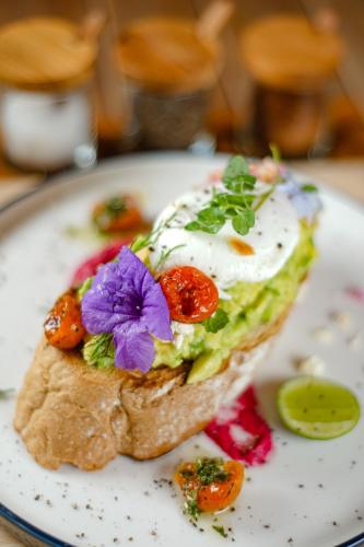 a piece of bread with eggs and vegetables on a plate at Bali Aroma Exclusive Villas in Seminyak