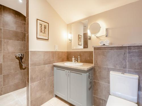 a bathroom with a sink and a toilet at The Little Barn in Woolverstone