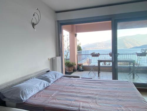 a bedroom with a bed and a view of the ocean at Casa Bella Vista- Punta Gaeta San Siro CO in San Siro