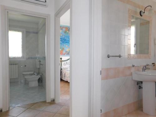 a bathroom with a sink and a toilet at Elegant villa in the idyllic island of Albarella in Isola Albarella