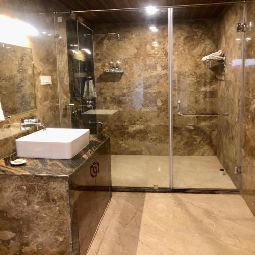 a bathroom with a sink and a shower at Amaira Resort & Farms - Mirik, West Bengal in Mirik