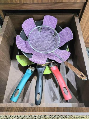 a wooden box with four different types of utensils at Villa Vimala Hills Semeru in Bogor
