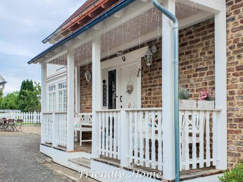 een witte veranda in een stenen huis met een witte leuning bij Friendly Home - "Gemütliches Backsteinhaus" Köln Bonn Phantasialand in Bornheim