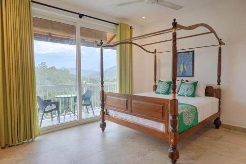 a bedroom with a canopy bed and a balcony at Kandyan Mount Mirror Boutique Villa in Kandy
