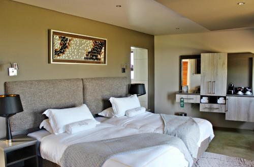 Ένα ή περισσότερα κρεβάτια σε δωμάτιο στο Thanda Tau