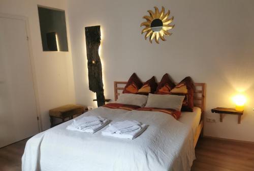 a bedroom with a bed with a mirror on the wall at Modern Studio Perauer in Gmünd in Kärnten