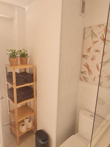 a bathroom with a toilet and a glass shower at Apartment Sky Cervantes in Málaga