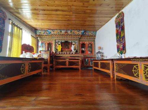 a large room with two beds and a wooden ceiling at Hello Home in Pelling