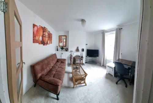 a living room with a couch and a desk at Two Bedroom End Terrace House near Birchington High Street in Birchington