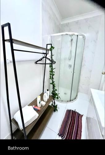 a bathroom with a large glass tank in a shower at Private entry studio room with bathroom and kitchen in Pendle Hills