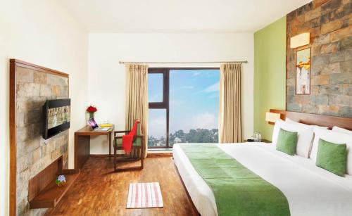 a hotel room with a large bed and a window at Sterling Mussoorie in Mussoorie