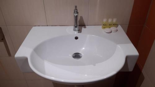 a white sink with a faucet in a bathroom at Baron Water Front in Kuah