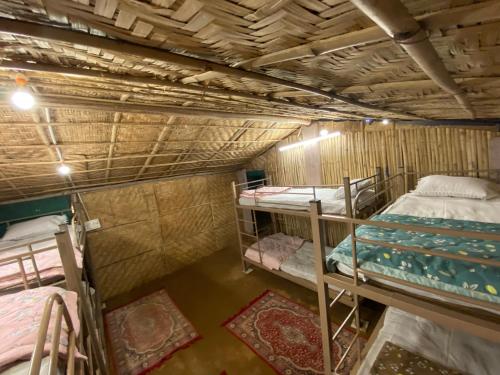 a room with two bunk beds and two rugs at Mystic Hive in Pushkar