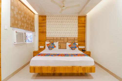 a bedroom with a bed in a room at FabHotel Holiday Grand in Patna