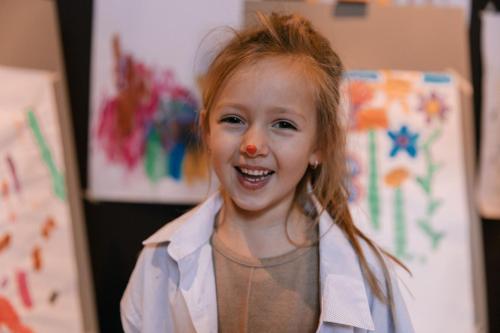 a little girl is smiling with a red hair at Hotel Steiner Superior in Obertauern