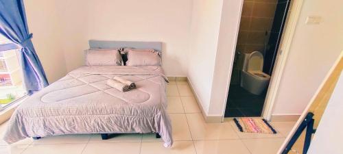 a small bedroom with a bed and a toilet at Kulai d putra suites beside ioiMall near JPO and Airport in Kulai