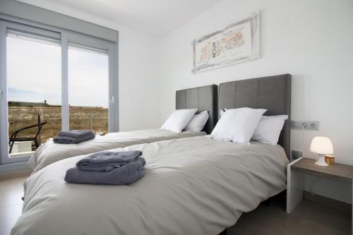 a bedroom with two beds and a large window at Villa Malibu 3021 in Vistabella